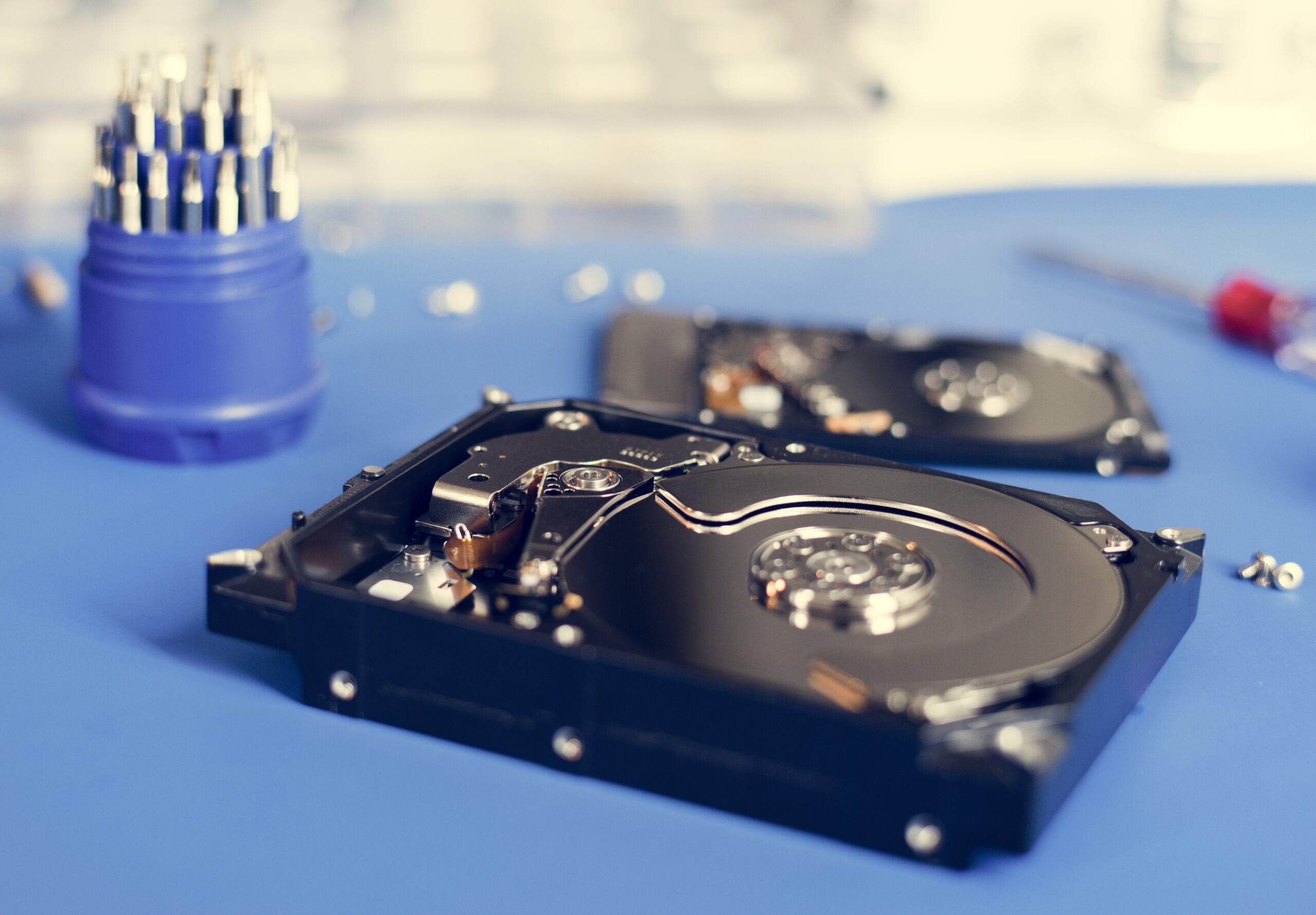 Offene Festplatte auf dem Reparaturtisch als Symbol für Datenverlust und Disaster Recovery Massnahmen